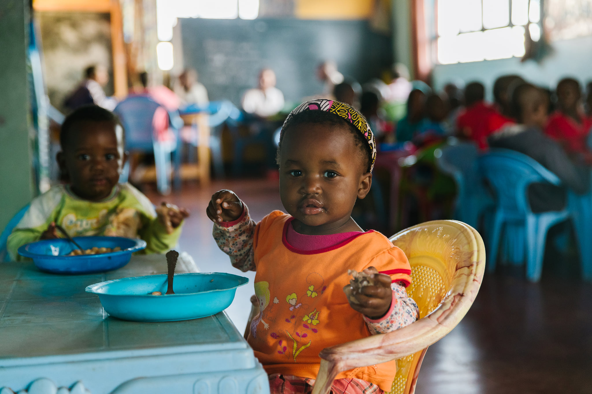 Child holding empty plate at mealtime